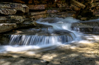 Dappled light falls.  Bemis Brook, New Hampshire